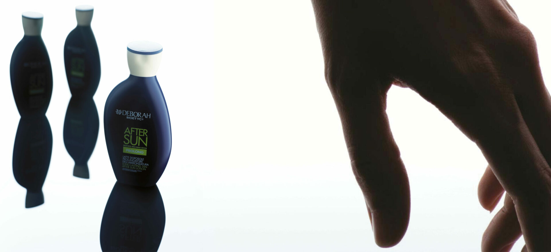 Three packages of Deborah Bioetyc After Sun product, and a close up view of a hand in a white background. In 2007 the packaging of the Bioetyc skincare line won the Good Design Award.