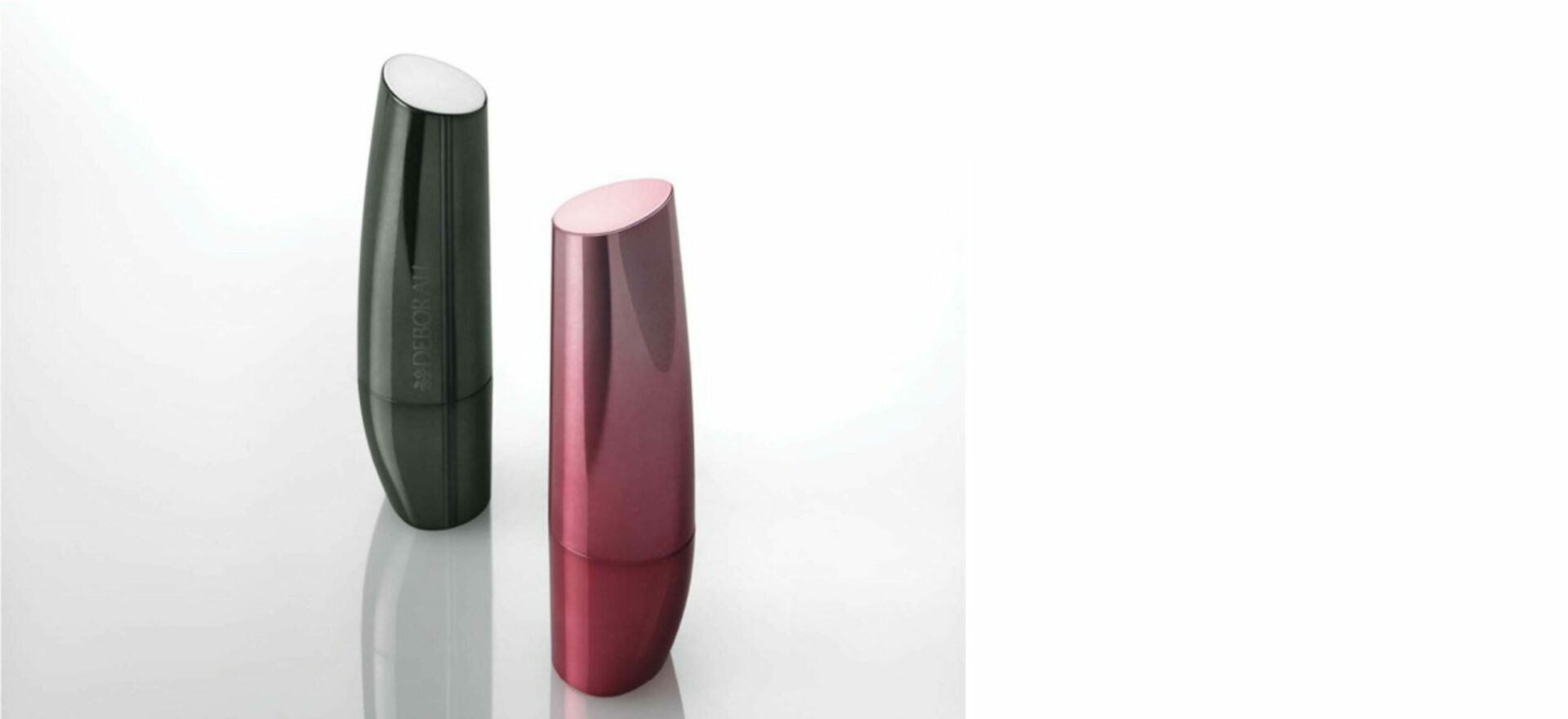 Two lipsticks standing up vertically, one black and one pink in a white background. In 2007 the packaging of the Bioetyc skincare line won the Good Design Award.