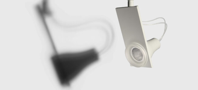 Iodo directional spotlight using 12V dichroic halogen, metal halid and 220-230V led lamp, designed for Artemide showing one of them hanging from the ceiling.