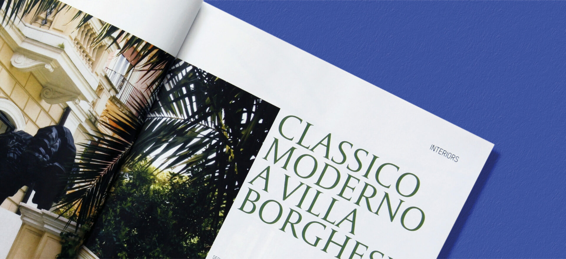 Close up photo of an opened Ville Giardini Magazine showing detail of the typography and composition of text and images used in the project of the Art Direction and Graphic Design for Visibilia Editore in a blue background.