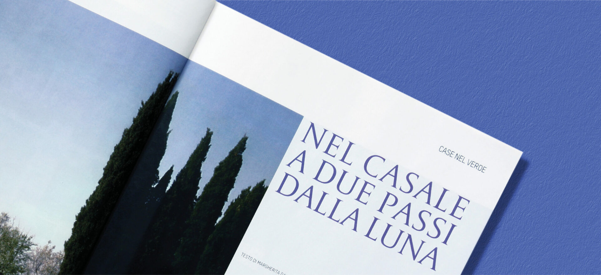 Close up photo of an opened Ville Giardini Magazine showing detail of the typography and composition of text and images used in the project of the Art Direction and Graphic Design for Visibilia Editore in a light blue background.